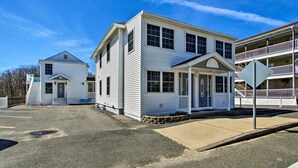 A two-story building with a front porch and a small staircase leading to the entrance. - Old Orchard Beach Apt - Walk to Beach & Pier! (Old Orchard Beach)