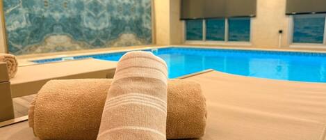 A poolside area with lounge chairs and towels.