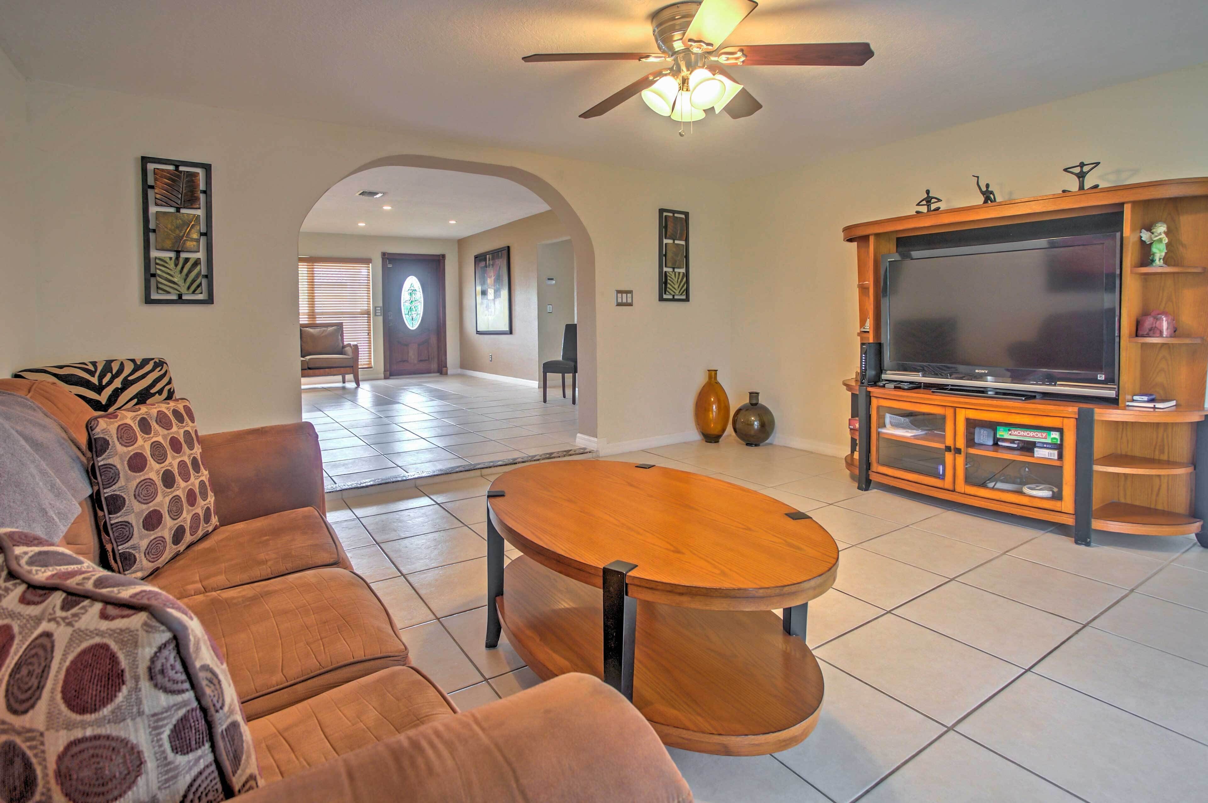 A living room with a sofa, coffee table, TV, and entertainment unit.