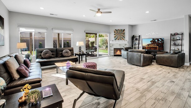 A spacious living room with a fireplace, leather sofas, and a flat-screen TV. - Near Downtown: Palm Springs Home w/ Mountain Views (Palm Springs)