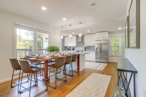 A modern kitchen with a central island, stainless steel appliances, and pendant lighting. - Private Dock: Lake Oconee Waterfront Escape! (Eatonton)