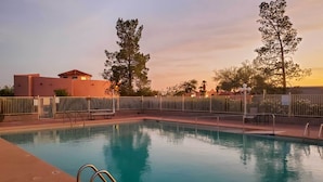 A rectangular swimming pool with a metal ladder on the left side, surrounded by a metal fence. - Rejuvenating Retreat w/ Ideal Eloy Location! (Eloy)