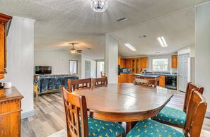 Cozy living area with a large dining table, comfortable seating, and a fully equipped kitchen.