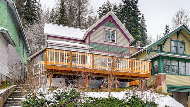 A two-story house with a wooden deck and a snow-covered roof. - 13 Mi to Skiing: Downtown Wallace Home w/ Deck (Wallace)