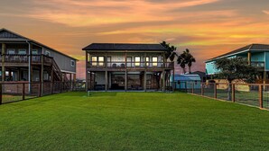 A two-story house with a large front yard and a balcony. - Nautical Nest 2 Bedroom Home (Rockport)