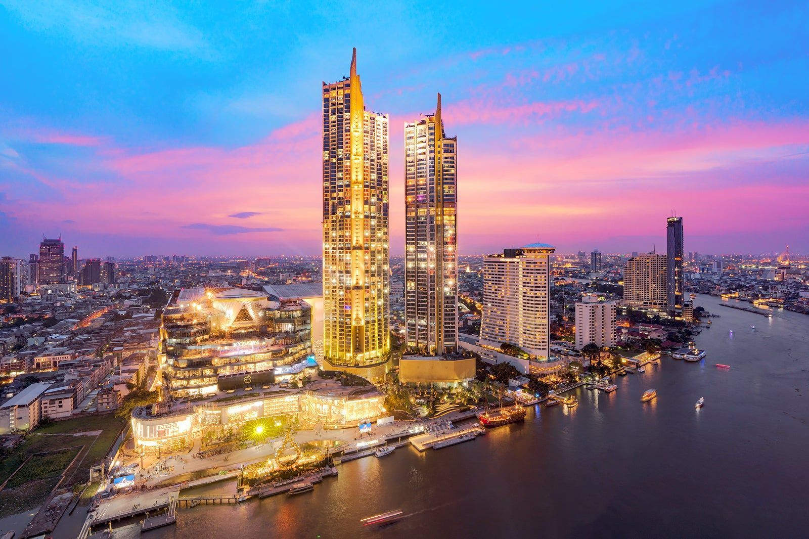 A cityscape with prominent skyscrapers, a waterfront, and a well-lit urban area.