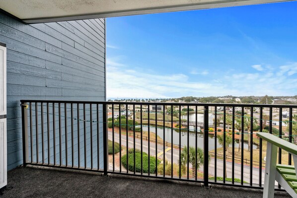 A balcony with a view of a parking lot and a body of water. - B444 at The Myrtle Beach Resort (Myrtle Beach)