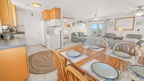 A compact living space with a kitchen, dining area, and seating area. - Soundfront Home in Frisco with Hot Tub, Private Dock and Windsurfing Access (Frisco)