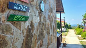 A stone wall with signs reading 'RESET,' 'RESTART,' and 'REFOCUS.' - Teras Otel Gökçeada (Gökçeada)