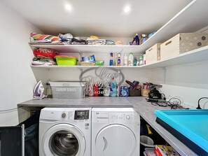 Convenient laundry facilities with two washing machines and a drying rack.