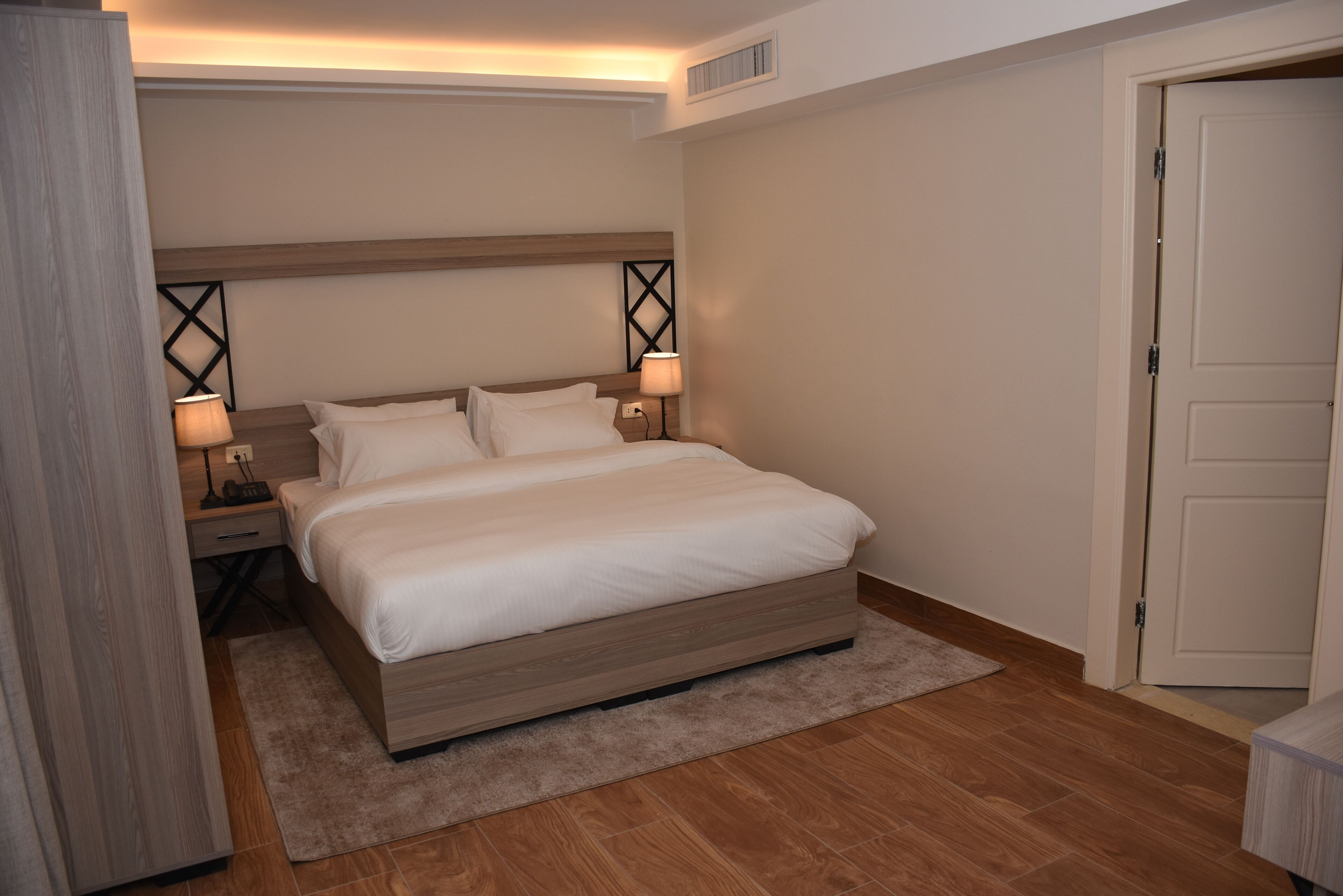 Suite Deluxe, vista a la ciudad | Minibar, caja de seguridad en la habitación y cortinas blackout 