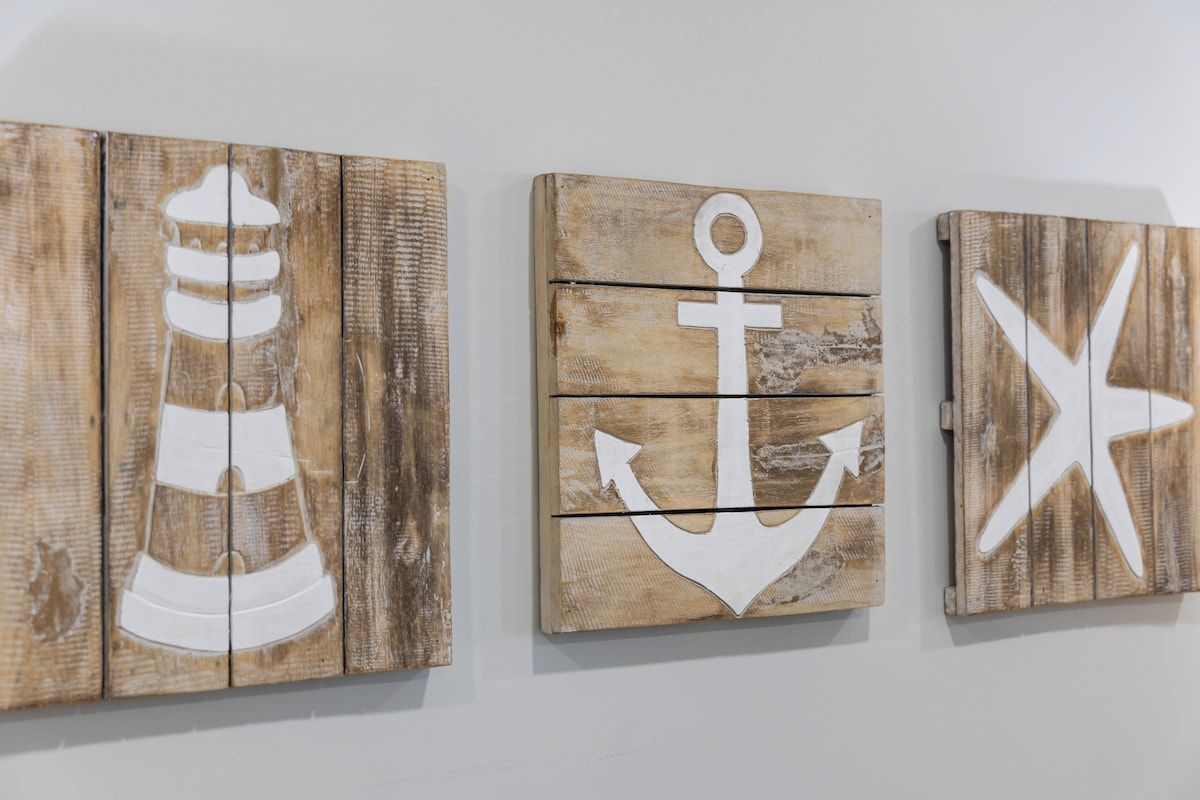 Three wooden panels with nautical symbols.