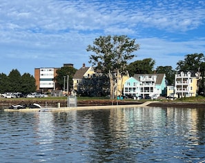 A waterfront property with multiple buildings, a dock, and a calm body of water. - Waterfront Posh King Studio Suite Downtown Ch'town (Charlottetown)
