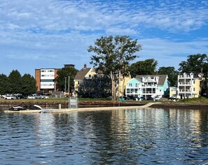 A waterfront property with multiple buildings, a dock, and a calm body of water. - Waterfront Deluxe King Suite Condo Downtown Chtown (Charlottetown)