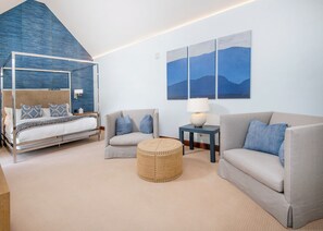 A modern bedroom with a four-poster bed, two sofas, a small round ottoman, and a nightstand with a lamp. - Spectacular Ritz Carlton Penthouse Residence in Vail. Two levels!! (Vail)
