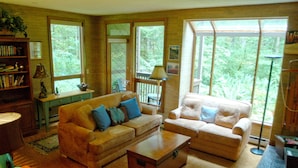 A cozy living room with two sofas, a coffee table, and a bookshelf.