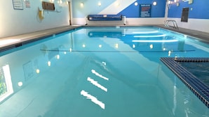 An indoor swimming pool with clear water, tiled walls, and a blue and white color scheme. - Snowater Condo #85 - Deluxe two Story Condo! (Deming)