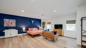 A modern living room with a bed, a sofa, a TV, and a ceiling fan. - Walk to Lake LV2 EV Charge Fish Hike Pickleball Skyline Club Coming Feb 25 3 Acre Property (Buchanan Dam)