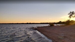 A beach with calm water and a clear sky. - Walk to Lake LV2 EV Charge Fish Hike Pickleball Skyline Club Coming Feb 25 3 Acre Property (Buchanan Dam)