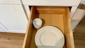 A drawer containing a white plate and a stack of white bowls. - Walk to Lake LV2 EV Charge Fish Hike Pickleball Skyline Club Coming Feb 25 3 Acre Property (Buchanan Dam)