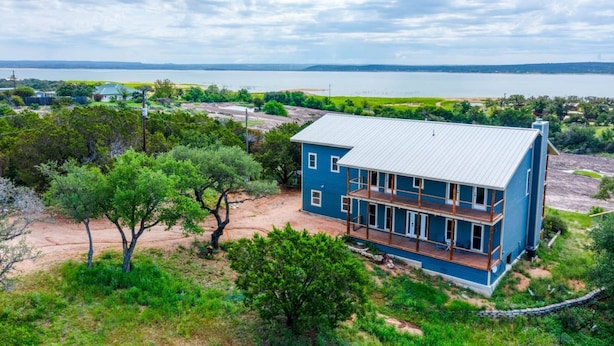 A two-story house with a balcony, surrounded by trees and a view of a lake. - Walk to Lake LV2 EV Charge Fish Hike Pickleball Skyline Club Coming Feb 25 3 Acre Property (Buchanan Dam)