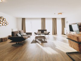 Deluxe Condo, Balcony, Mountain View | Living area | Flat-screen TV