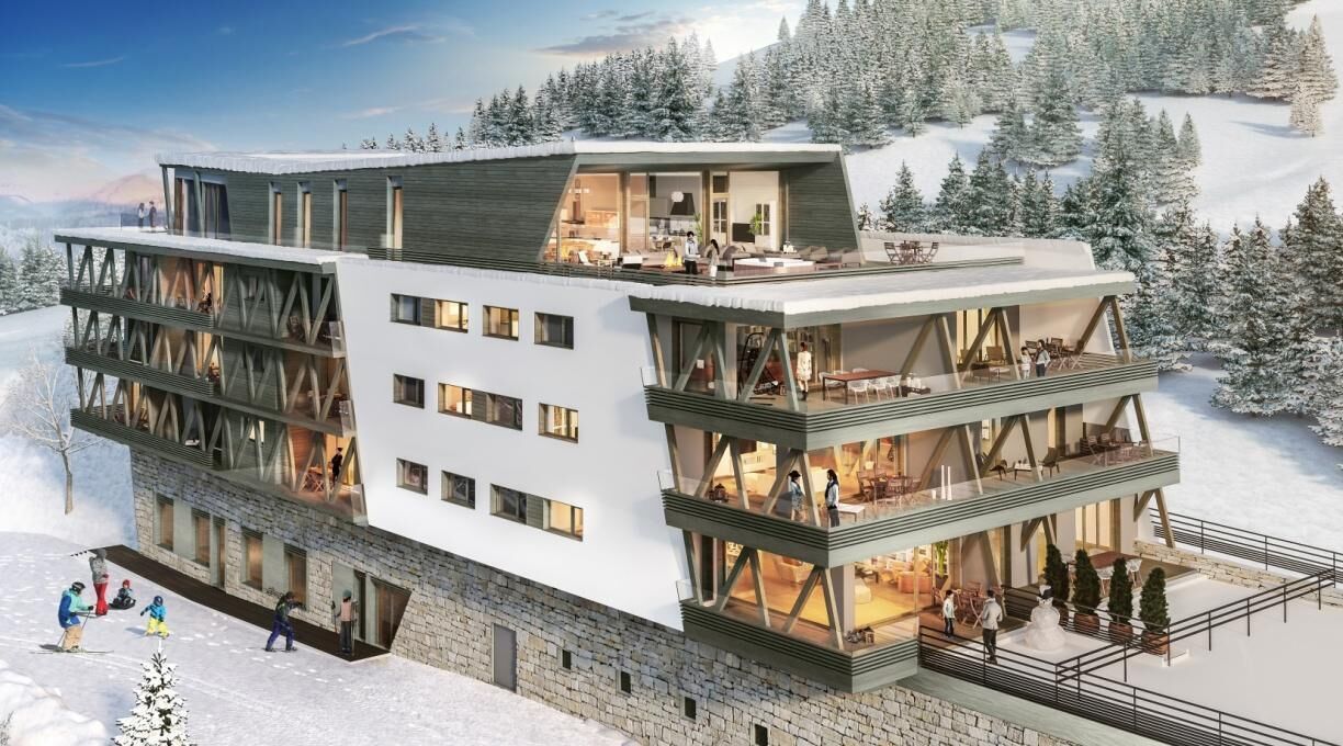 A multi-story hotel with a modern design, featuring balconies and large windows.