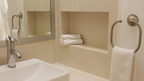 A bathroom with a sink, mirror, towel rack, and a shelf with towels. - Azcapri Villa-Boutique & Spa (Cancun)