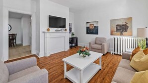 Un salon moderne avec une cheminée, un téléviseur à écran plat, un canapé et une table basse.