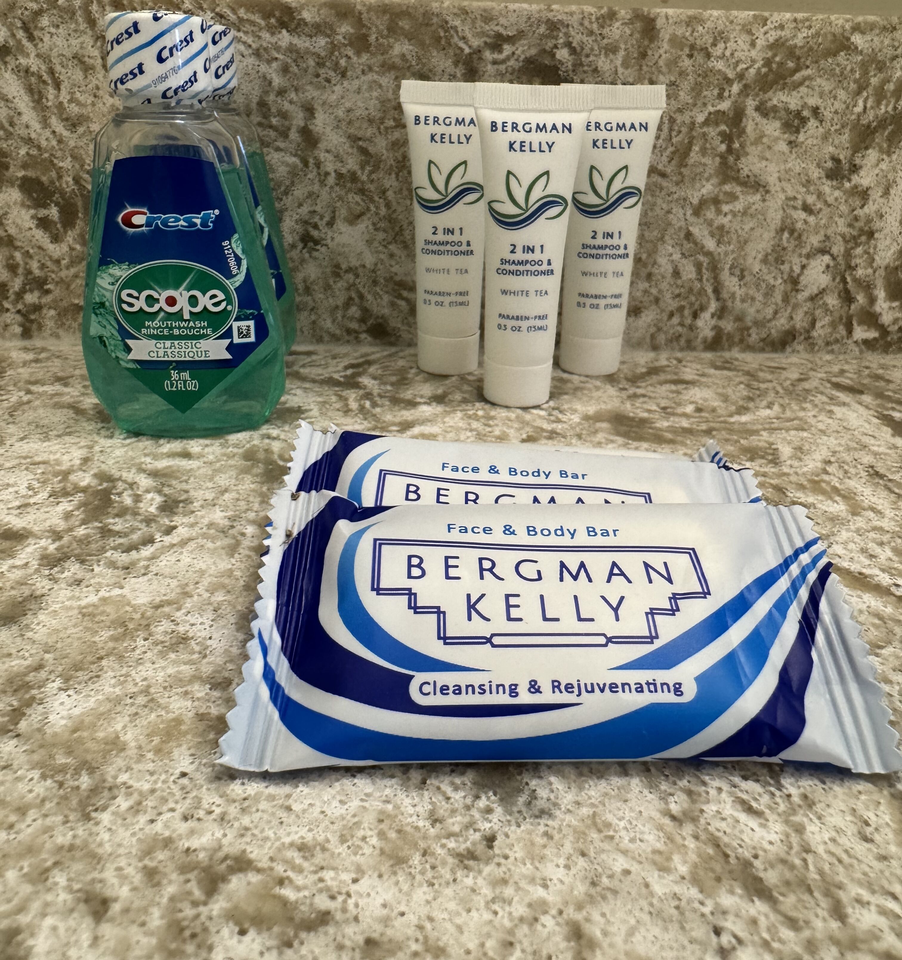 Crest mouthwash, Bergman Kelly shampoo and conditioner, and Bergman Kelly face and body bar on a countertop.