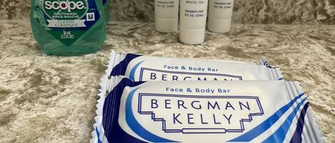 Crest mouthwash, Bergman Kelly shampoo and conditioner, and Bergman Kelly face and body bar on a countertop.