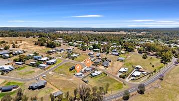 An aerial view of a residential area with houses, roads, and open spaces.