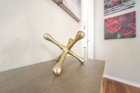 A brass decorative object on a wooden surface.