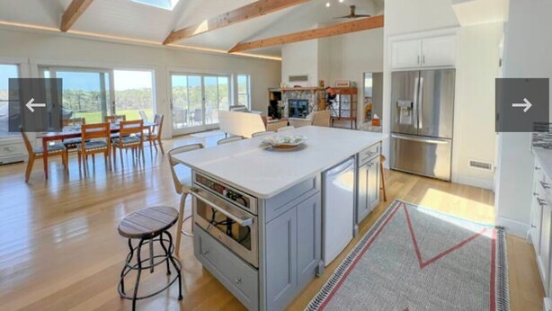 A spacious kitchen with a large island, wooden beams, and a view of the outdoors. - Charming 6 bdr house-Chappaquiddick near Edgartown, beaches, 20x60pool,amenities (Edgartown)
