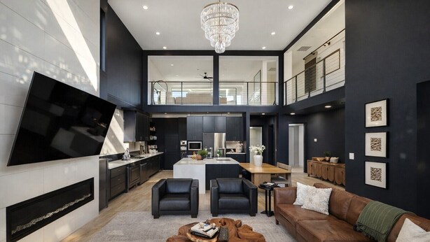 A spacious living area with a large flat-screen TV, a wooden coffee table, and a brown leather sofa. - Downtown Dallas Home  (Dallas)