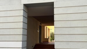 A building entrance with a set of stairs leading to a door.