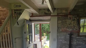 A rustic interior with a staircase, a dining area, and a view of the garden. - Stunning views beautiful old farmhouse Peaceful overlooking  bay & mountains (Tuosist)