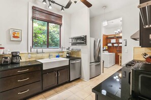 A modern kitchen with a large window, built-in appliances, and a clean, organized layout. - New! Stately Home w Modern Flair Centrally Located (New Orleans)