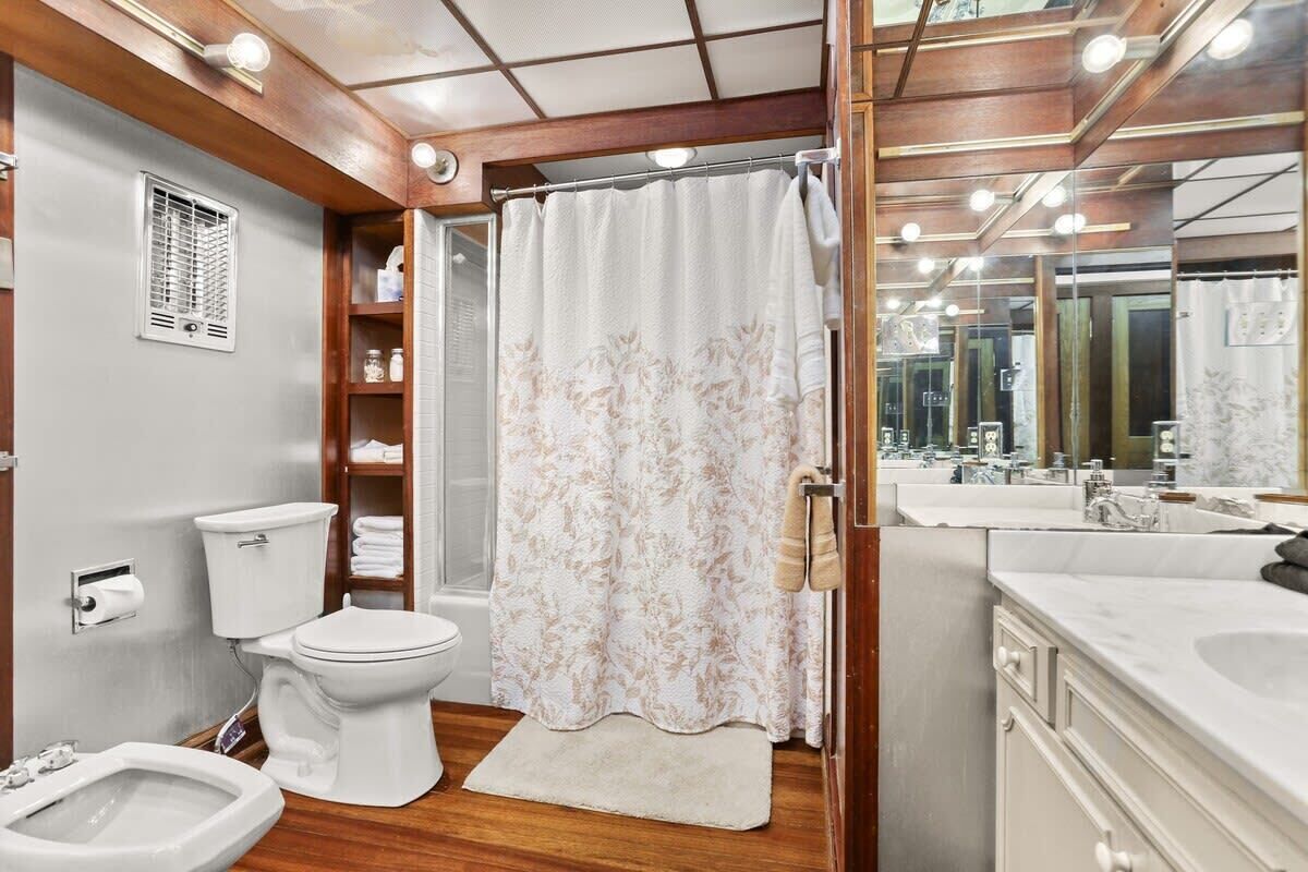 A modern bathroom with a toilet, bidet, and sink.