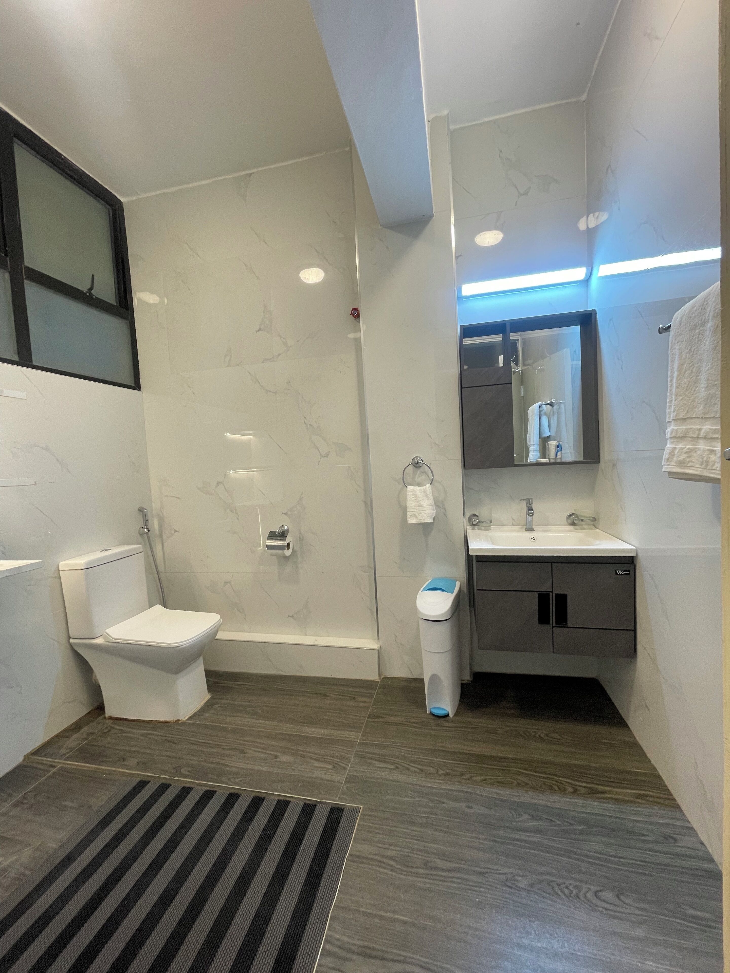 Shower, rainfall showerhead, slippers, towels