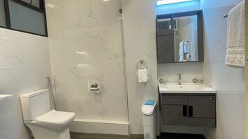 Shower, rainfall showerhead, slippers, towels