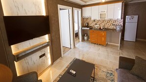 Een modern appartement met een woonkamer, keuken en eetgedeelte.