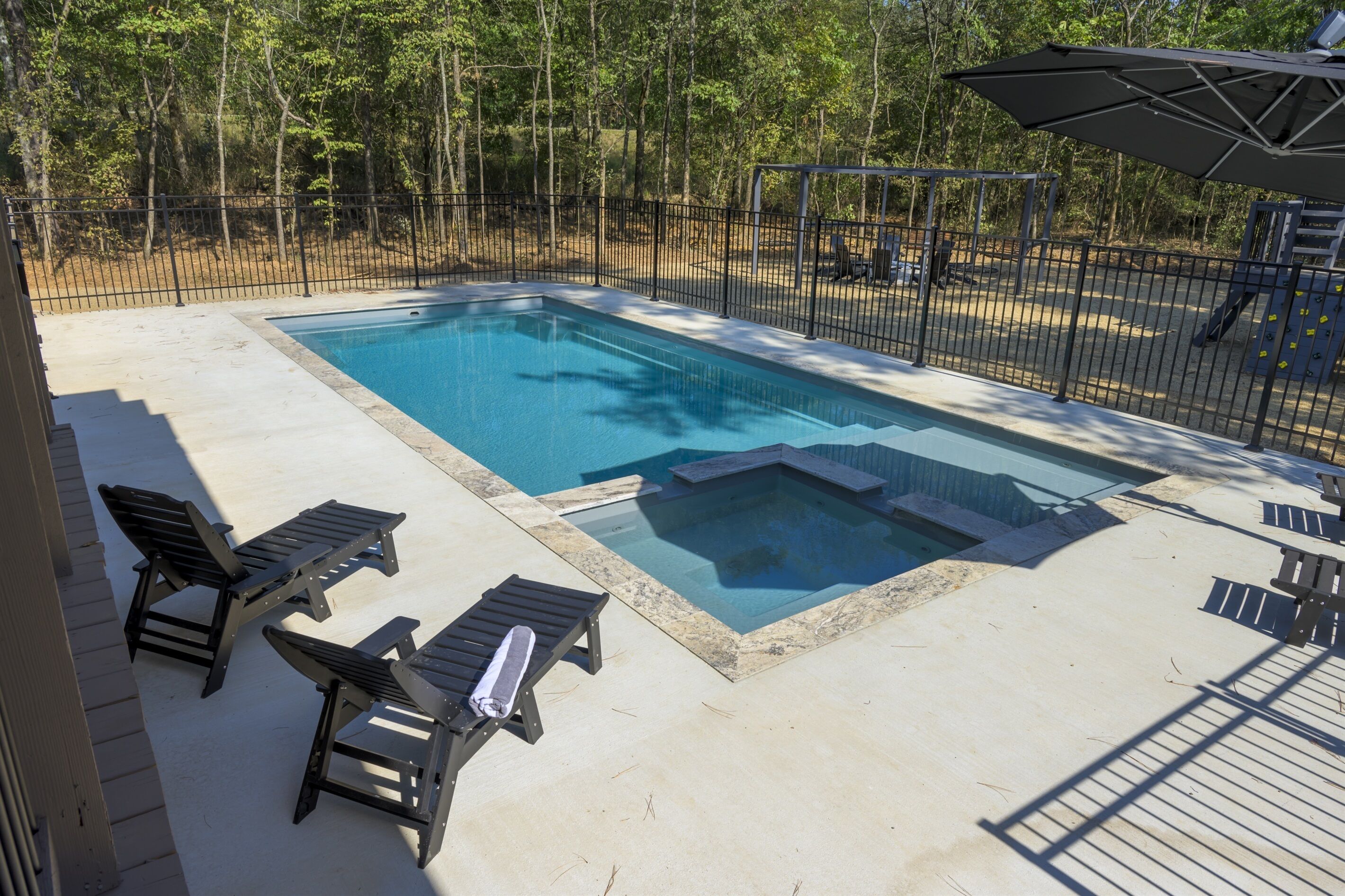 The pool overlooks to the play set and fire pit area.