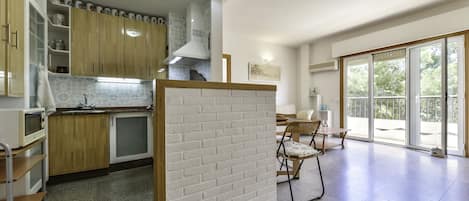 Enjoy meals in the kitchen with a microwave and adjacent dining area featuring a table and chairs.