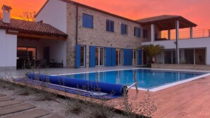 A two-story house with a swimming pool, stone walls, and blue shutters. - Amazing home in Rapavel with sauna (Rapavel)