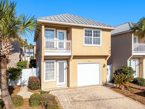 Enjoy a home away from home in this two-story residence with a garage and balcony overlooking beautifully maintained gardens.