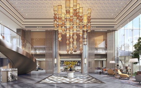 A spacious lobby with a modern chandelier, a central seating area, and a unique spiral staircase.