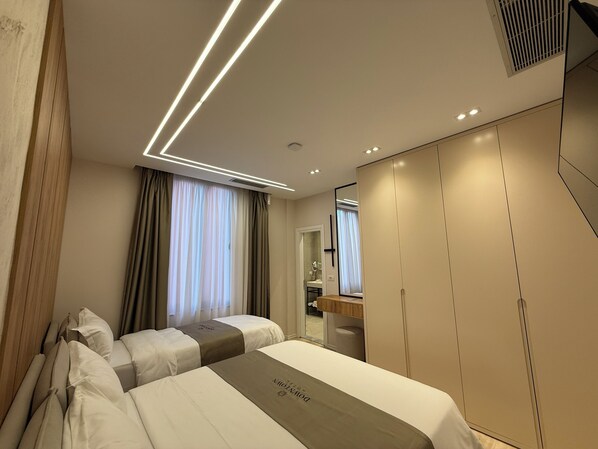 A hotel room with a large bed, a wardrobe, and a bathroom visible through a door.