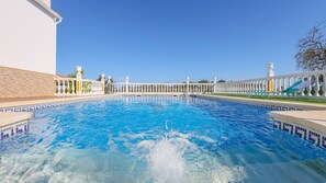 A large, clear swimming pool with a white balustrade and a tiled edge. - Casa Albahacar Paymogo by Ruralidays (Huelva)