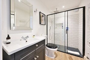 Shower, hair dryer, towels, shampoo